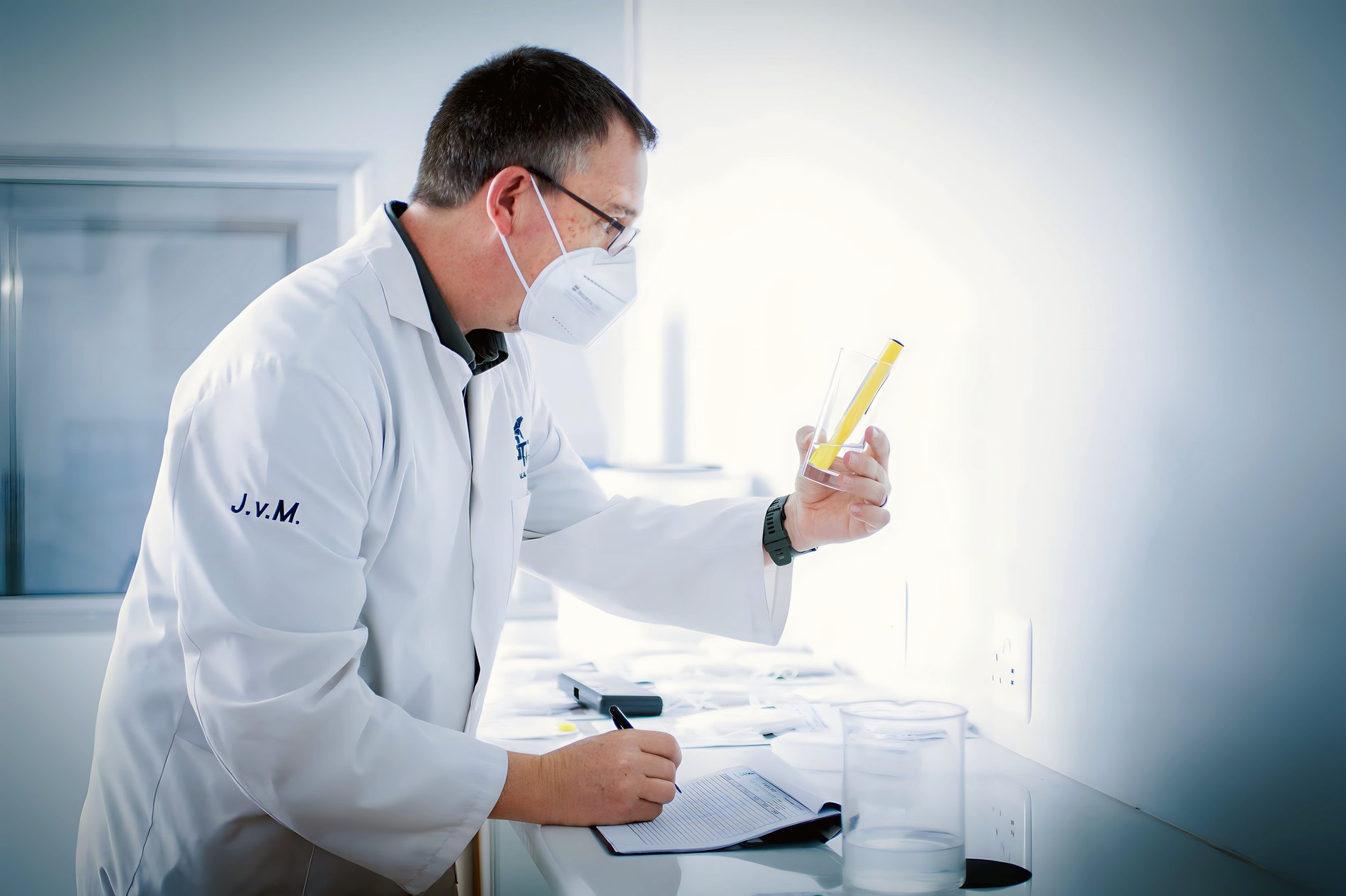 An Elara-Cortex scientist examining a sample under quality control in the clean lab